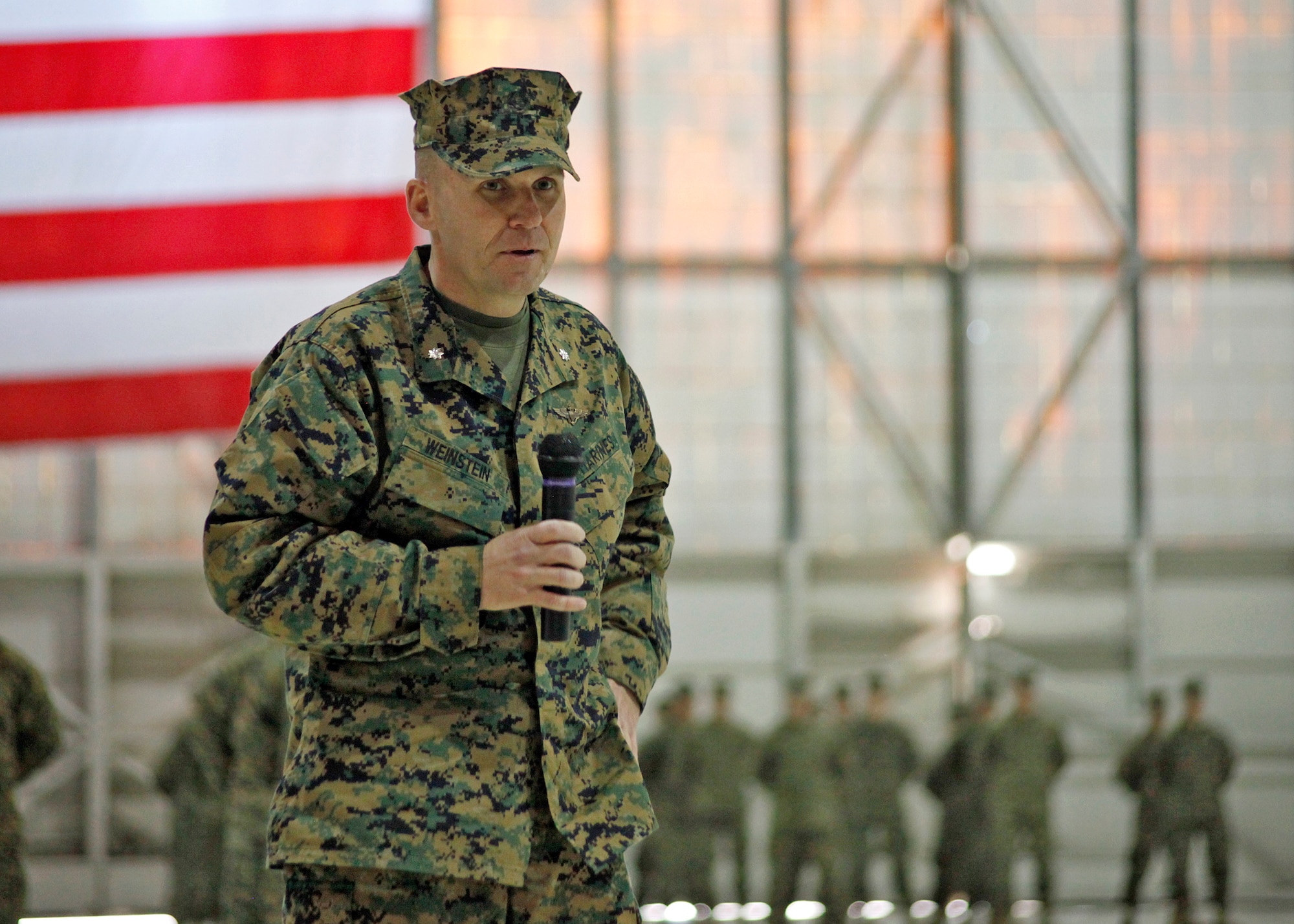 U.S. Marine Corps Lt. Col. David Weinstein (center) speaks to attendees after assuming command of the newly re-designated Marine Medium Tiltrotor Squadron 764 Jan. 12, 2013, in Hangar 1210. From here, the squadron will re-locate to Marine Corps Air Station Miramar in San Diego, Calif. (U.S. Air Force photo by Jet Fabara)
