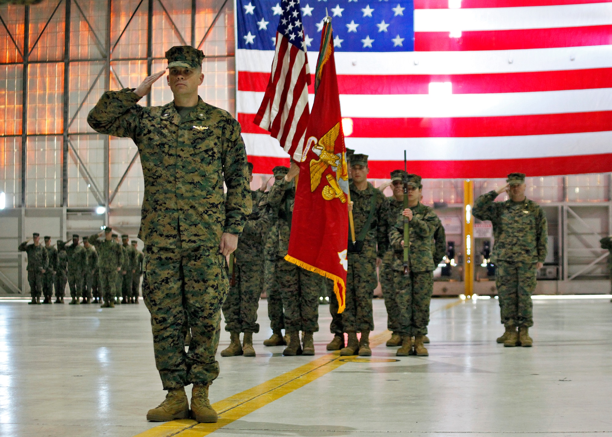 U.S. Marine Corps Lt. Col. Scott Craig salutes his squadron one last time before relinquishing command of the newly re-designated Marine Medium Tiltrotor Squadron 764 to Lt. Col. David Weinstein on Jan. 12, 2013, in Hangar 1210. From here, the squadron will re-locate to Marine Corps Air Station Miramar in San Diego, Calif. (U.S. Air Force photo by Jet Fabara)