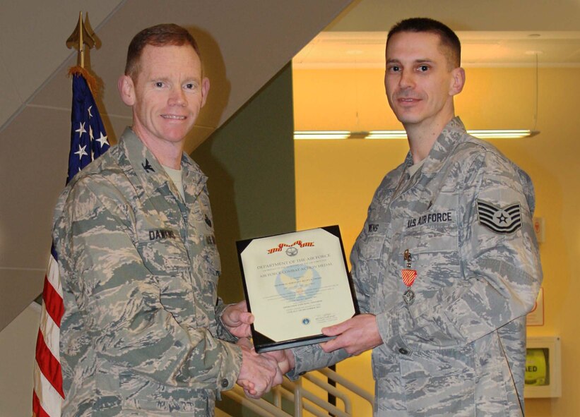MINOT AIR FORCE BASE, N.D. -- Tech. Sgt. Shawn Owens, 5th Medical Operations Squadron operational medicine flight chief, recently earned distinguished military decorations for going above the call of duty during multiple deployments. Col. James Dawkins Jr., the recently departed 5th Bomb Wing commander, presented Owens the Air Force Combat Action Medal and the Purple Heart here, Jan. 10. (U.S. Air Force Photo/Kiley Swopes) 