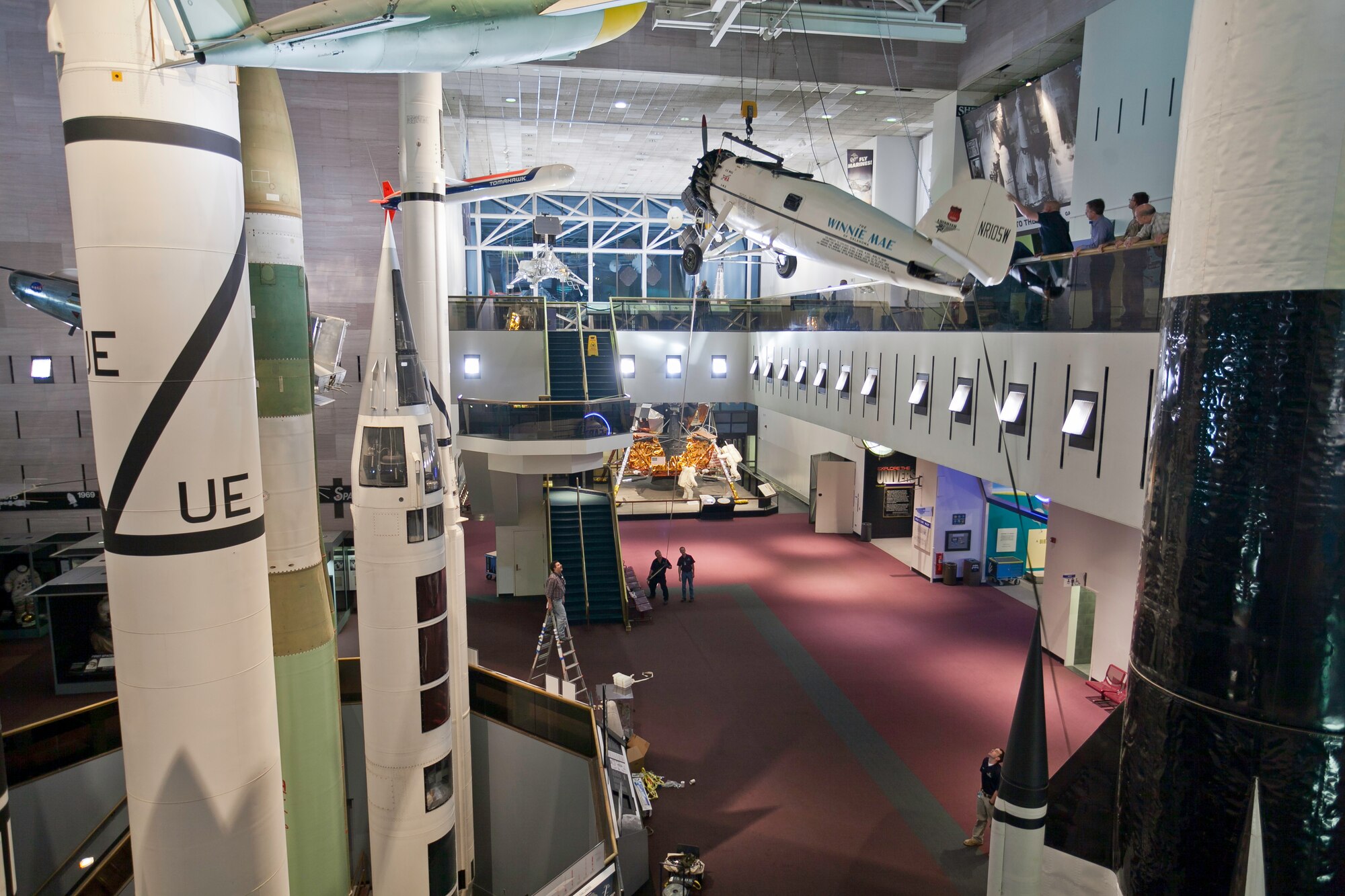 The fuselage of Wiley Post's Winnie Mae, an aircraft used to break around-the-world flight records in 1931 and 1933, is lifted by crane to the second floor of the National Air and Space Museum in Washington, DC, for installation in the new Time and Navigation exhibit, currently under construction. (Photo by Benjamin Sullivan, National Air and Space Museum, Smithsonian Institution)
  
