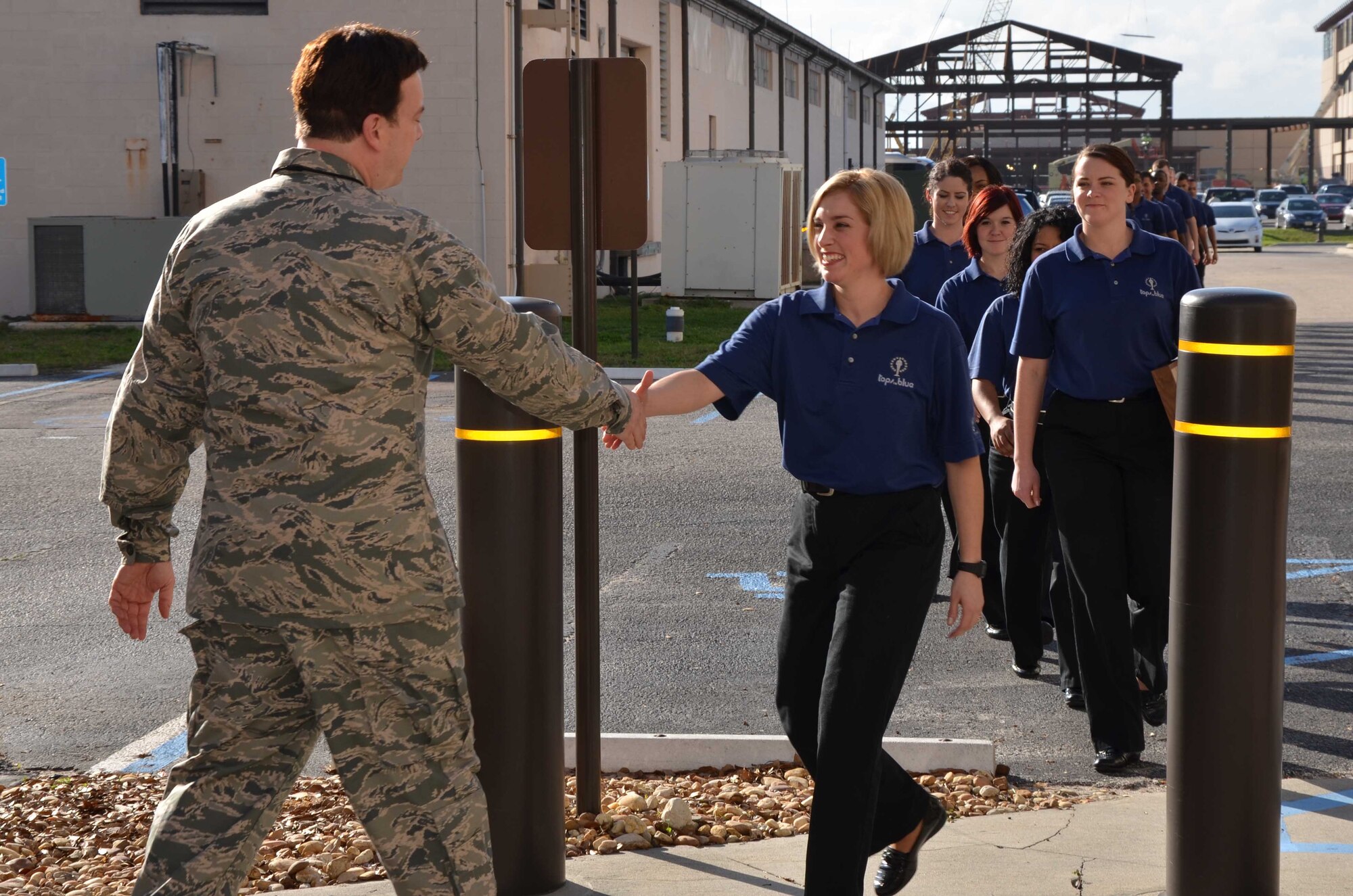 Welcome back!  Col. Chris Worley (left), commander of the Air Force Technical Applications Center, extends a warm handshake to Senior Airman Kerrilee Meeker upon her temporary return to her work center.  Meeker has been traveling and performing with Tops in Blue, the U.S. Air Force's premier entertainment showcase, since March 2012 and was in town for a performance at the Maxwell C. King Center for the Performing Arts.  She and 20 of her fellow vocalists sang a few songs for AFTAC personnel and presented Worley with a token of appreciation for 'loaning' Meeker to the team for a year.  (U.S. Air Force photo by Susan A. Romano)