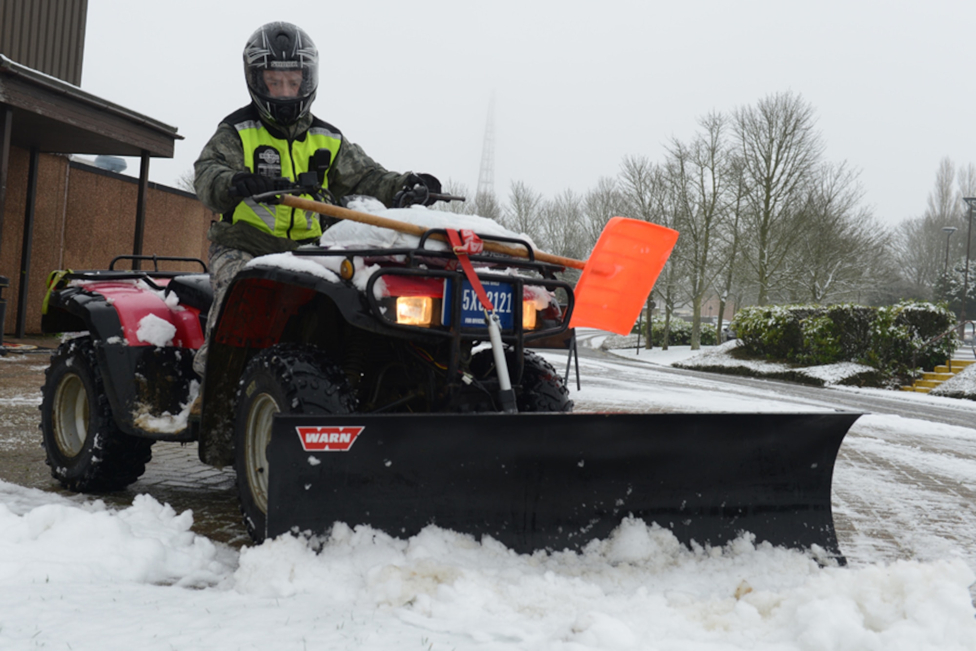 RAF CROUGHTON, United Kingdom - Staff Sgt. Brian Gubicza, 422nd Civil Engineer Squadron power production shop, clears snow from the walkways around Building 200 on RAF Croughton Jan. 14. RAF Croughton received its first snow of the year and the 422nd CES cleared the streets and roads around the base. (U.S. Air Force photo by Tech. Sgt. Chrissy Best)