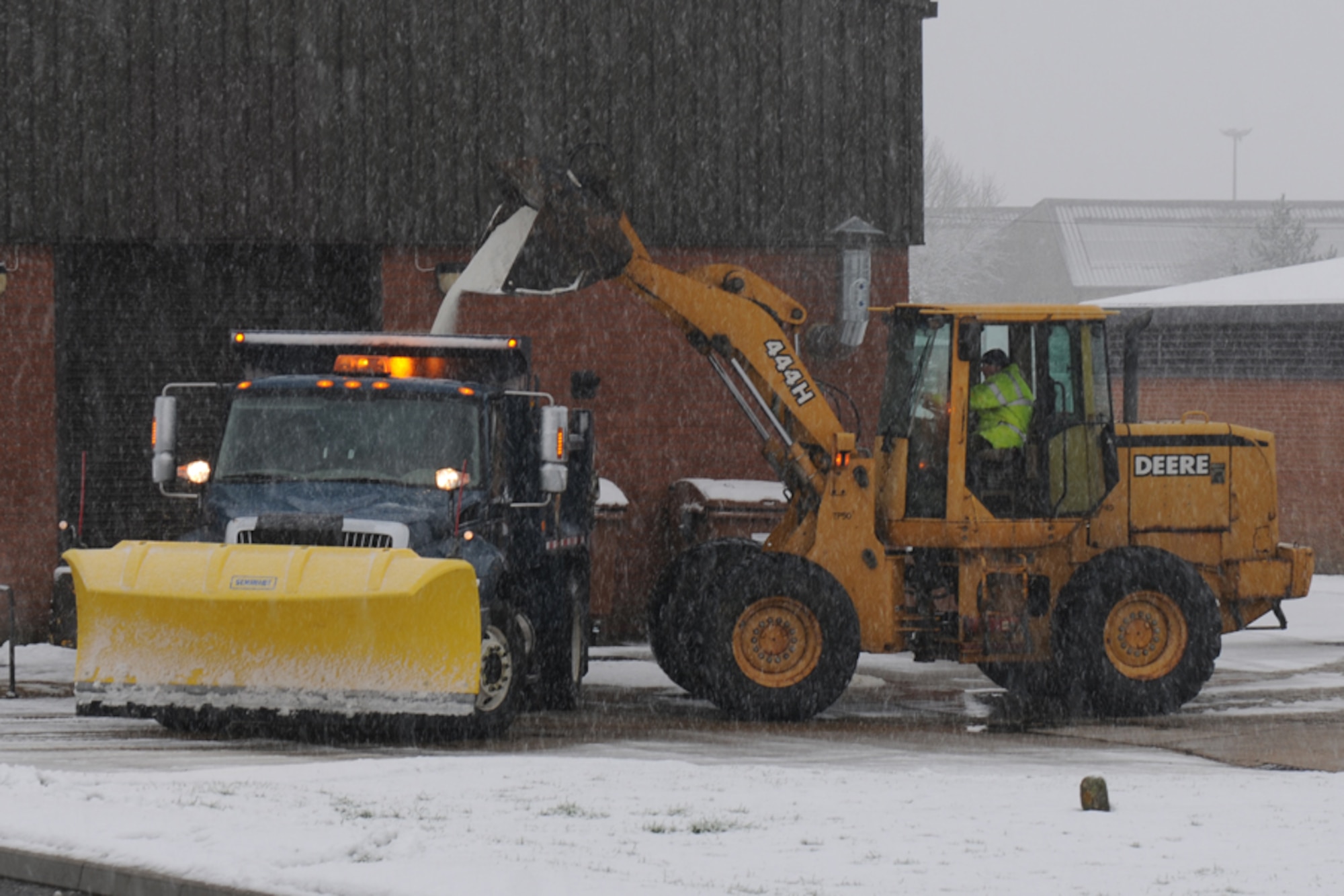 RAF ALCONBURY, United Kingdom – Members of the 423rd Civil Engineer Squadron load salt into the back of a snowplow at RAF Alconbury Jan. 14. The plow was clearing and salting the roads on RAF Alconbury as the base received its first snow of the year. (U.S. Air Force photo by Capt. Brian Maguire)