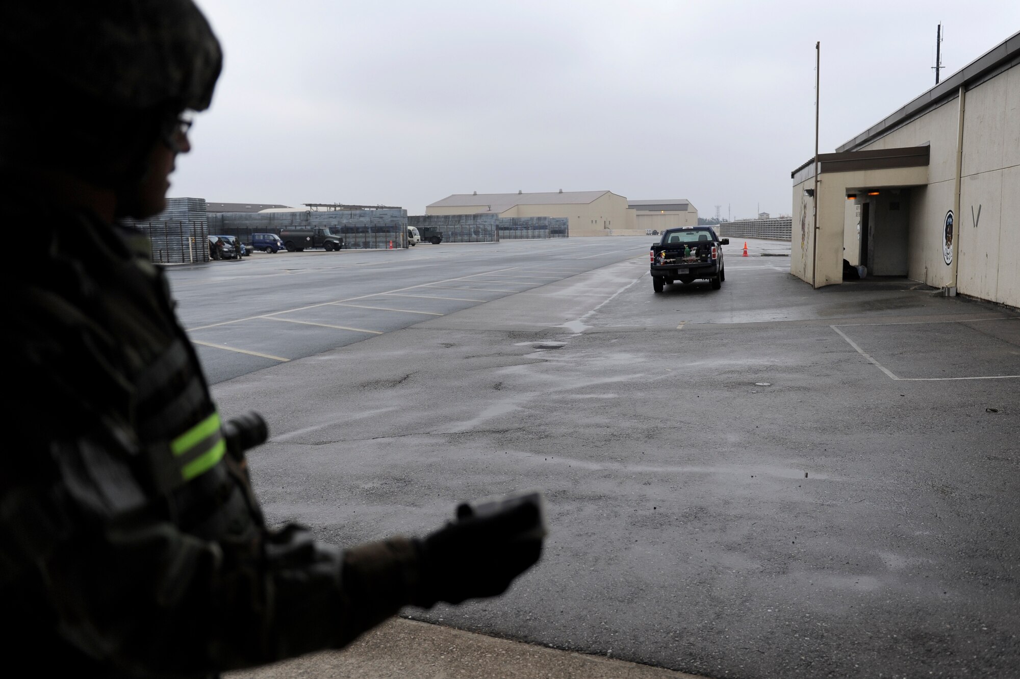Tech. Sgt. Jeffrey Marks, 8th Fighter Wing Safety Office exercise evaluation team member, sets off a simulated tactical ballistic missile using a ground blast simulator during exercise Beverly Midnight 13-1 at Kunsan Air Base, Republic of Korea, Jan. 16, 2013. The scenario tested the Airmen’s ability to evacuate a building on fire and continue mission operations at another location. (U.S. Air Force photo by Senior Airman Marcus Morris/Released) 