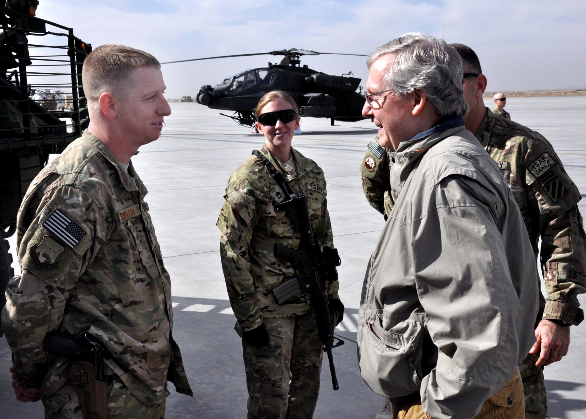 U.S. Air Force Staff Sgt. Ted Cameron, 451st Air Expeditionary Wing protocol, speaks with U.S. Senator Mitch McConnell (R-KY) during the Senator’s visit to Kandahar Jan. 14. McConnell along with U.S. Senators John Barasso (R-WY) and Senator-Elects Jeff Flake (R-AZ), Ted Cruz (R-TX) and Deb Fischer (R-NE) visited Regional Command-South leadership, Soldiers and Airmen. The purpose of the visit was to discuss the political, economic and security issues affecting bilateral and regional relationships in the RC-South area of operations. (U.S. Air Force photo/Master Sgt. Russell Martin)