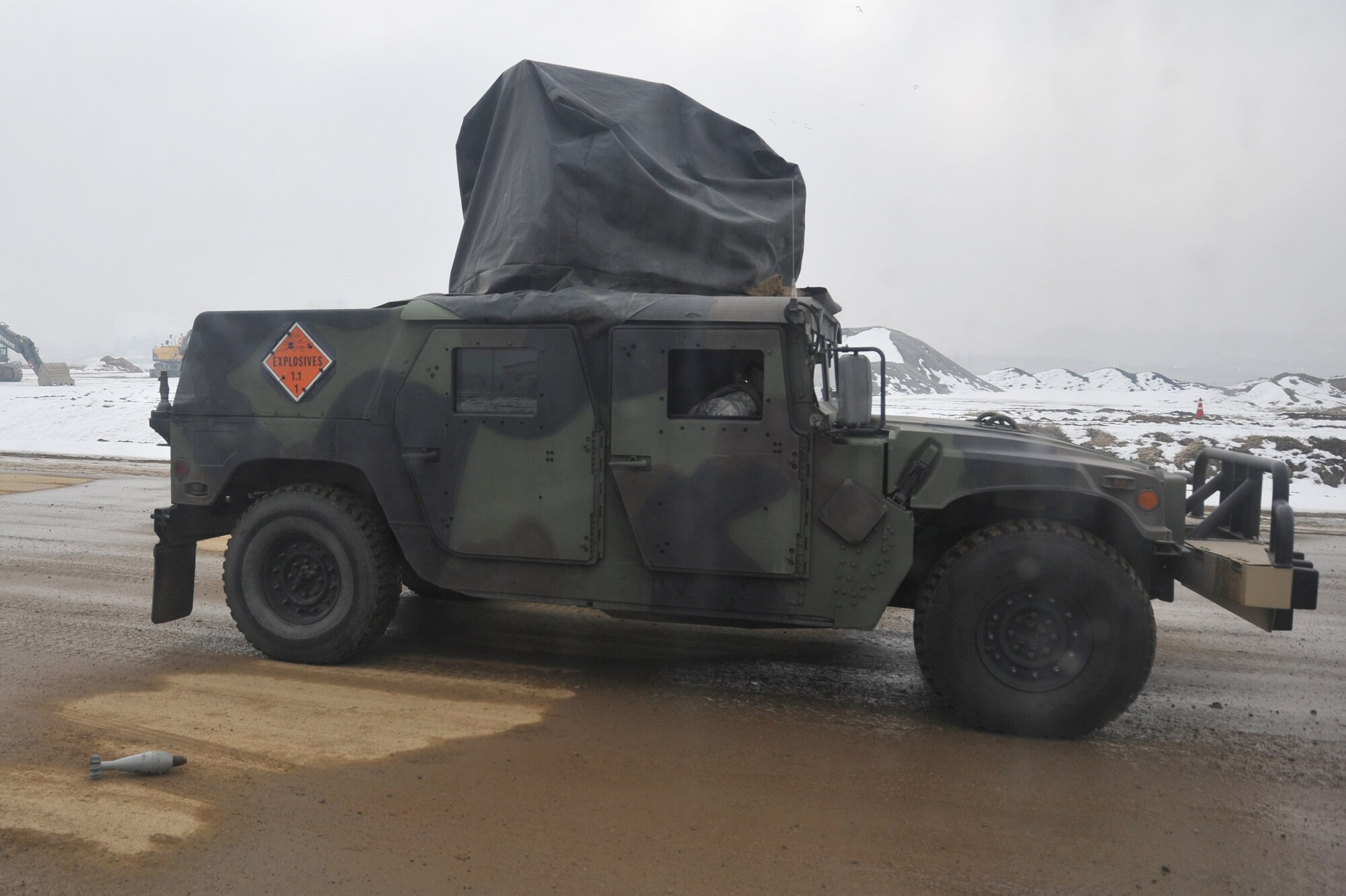 The Explosive Ordinance Disposal Flight team reports on-scene to a simulated flight line to respond to an Unexploded Ordinance on Osan Air Base, Republic of Korea, Jan. 14, 2013. EOD reports any damage done to the flight line to the Emergency Operations Center to be plotted on a map at the Air Field Danage Repair pad. Reporting teams consist of an EOD Airman and an engineer assistant. (U.S. Air Force photo/Staff Sgt. Emerson Nunez)
