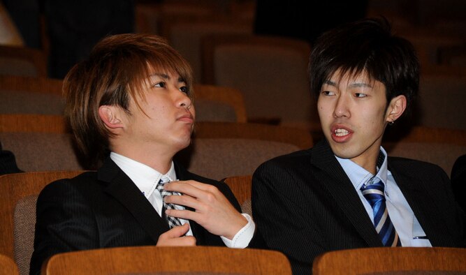 A young man straightens his tie before the Coming of Age Day Ceremony at the Misawa Civic Center in Misawa City, Japan, Jan. 13, 2013. The traditional garb for this type of ceremony is a dark kimono with hakama, a type of pants, but young men are generally seen wearing western style suits to the ceremony. (U.S. Air Force photo/Airman 1st Class Kenna Jackson) 
