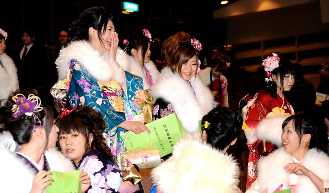 Young women dressed in their furisodes, gather to celebrate their maturity during the Coming of Age Day Ceremony at the Misawa Civic Center in Misawa City, Japan, Jan. 13, 2013. As a sign of adulthood, women celebrated in a special type of kimono with long sleeves that drape down and elaborate designs, and zori sandals. (U.S. Air Force photo/Airman 1st Class Kenna Jackson 
