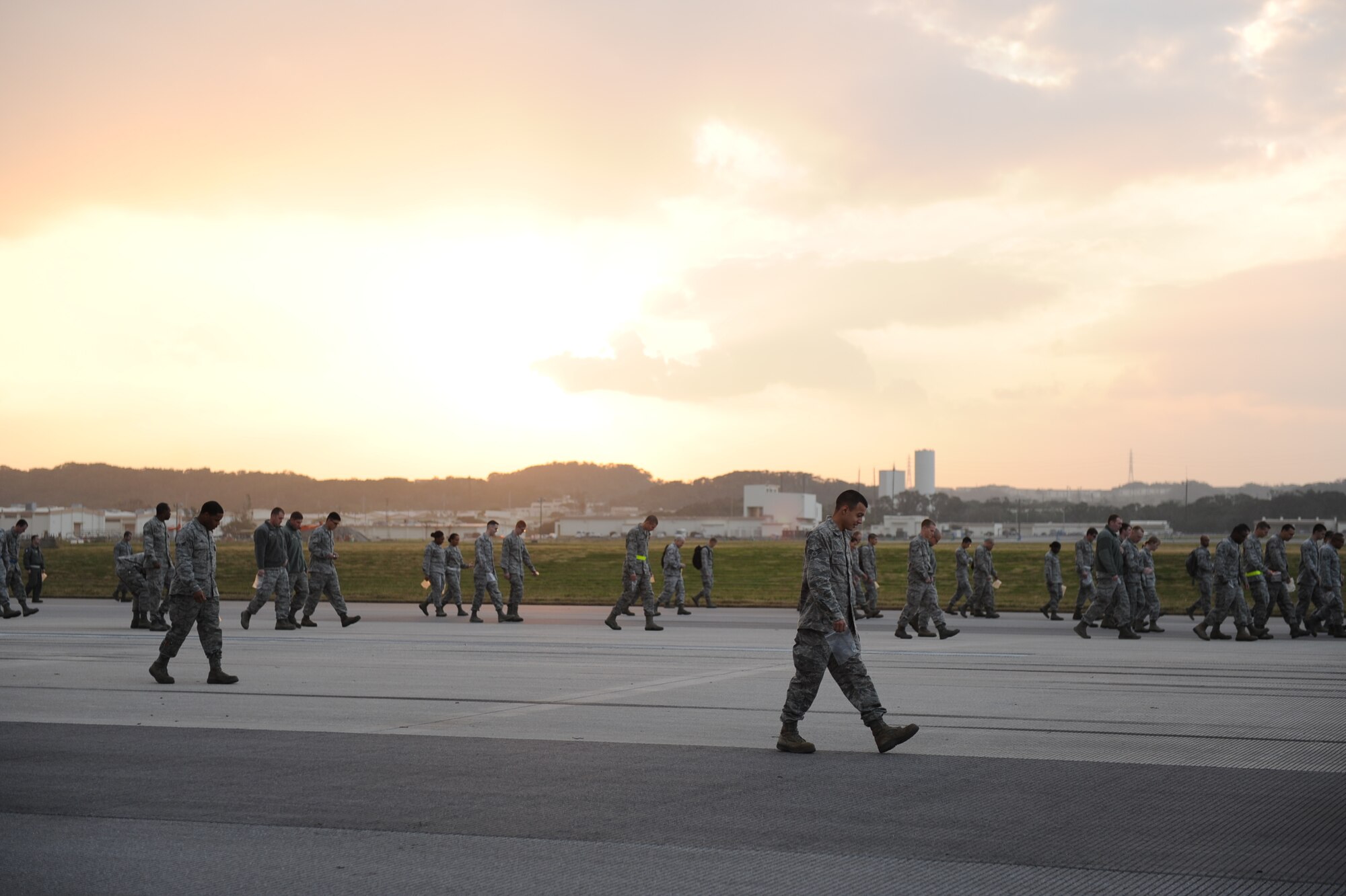 U.S. Air Force Airmen from Kadena Air Base walk along a strip of runway looking for foreign objects and debris on Kadena Air Base, Japan, Jan. 14, 2013. Conducting a FOD walk will allow more eyes to look for rocks or trash that can save not only machinery but Airmen’s lives. (U.S. Air Force photo by Airman 1st Class Brooke P. Doyle)
