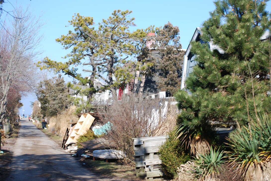 Fire Island, N.Y. - Close quarters and narrow egress paths make for challenging debris removal following the destruction caused by Hurricane Sandy. The Corps continues to work with all of its federal, state and local partners as we support the townships on Fire Island in their recovery effort.