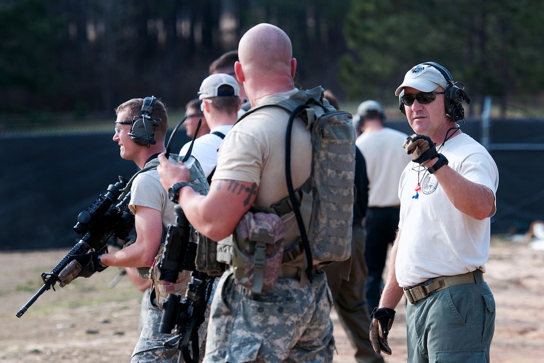 Jeff Haskell, right, an nstructor, teaches advanced rifle marksmanship ...