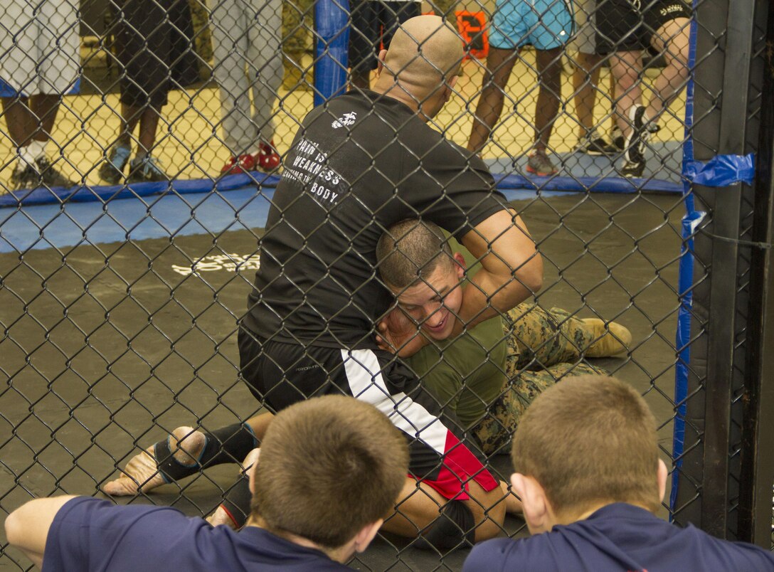 Marines teamed up with MMA instructors to give poolees from Recruiting Substation North Milwaukee a martial arts demonstration at Team Knockout MMA & Fitness gym here Jan. 12.  For more photos, visit: http://www.facebook.com/rsmilwaukee.