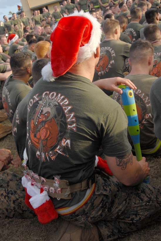 MARINE CORPS BASE HAWAII - Dressed for the festive occasion, Cpl. Richard Barton, squad leader, Fox Company, 2nd Battalion, 3rd Marine Regiment, listens to remarks by the command sergeant major and commanding officer of 2nd Bn., 3rd Marines, Dec. 21, 2012. The unit went on a three-mile morning run, with many of the service members carrying toys and wearing festive decor. The unit collected more than 700 toys for the program. "We know a lot of families (and military families) benefit from (Toys for Tots)," said Maj. Brian Harvey, operations officer, Headquarters and Service Company, 2nd Bn., 3rd Marines. "This is our way of giving back." After the run, the Island Warriors loaded the toys into a truck and enjoyed some breakfast and social time. This is the unit's second year giving to Toys for Tots. Last year, they went on a hike, carrying gear and toys. "It's a fun way to start the holiday season and give back to the local community," said Lt. Col. Justin S. Dunne, 2nd Bn., 3rd Marines commanding officer. (Official U.S. Marine Corps photo by Kristen Wong) 
