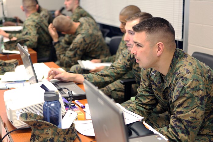 Marines with Combat Logistics Battalion 6, 2nd Marine Logistics Group await confirmation of team positions through the use of communication devices during an exercise aboard Camp Lejeune, N.C., Jan. 15, 2013. Servicemembers in the command operations center tracked and monitored the 10 teams arriving and departing checkpoints and plotting them on a map. 