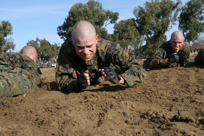 Recruits of Company C low crawl as part of the Combat Conditioning Exercise they participated in Jan. 9.