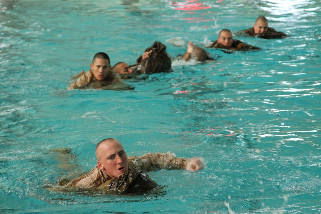 Recruits of Company K, 3rd Recruit Training Battalion, use a waterproof pack to swim 25 meters in the water during Water Survival Basic aboard Marine Corps Recruit Depot San Diego Jan. 7. 