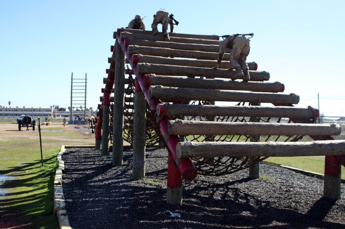 Recruits of Company M, 3rd Recruit Training Battalion, weave through the logs of an obstacle inthe Confidence Course during the Crucible at Edson Range aboard Marine Corps Base Camp Pendleton, Calif., on Jan. 9. The Confidence Course is part of the 54-hour combat simulation recruits must work through in order to earn the title "Marine."