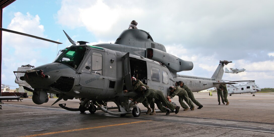 Marines push a UH-1Y Venom helicopter into a hangar Jan. 14 at Marine Corps Air Station Futenma. Every day, Marines move aircraft into hangars to conduct routine maintenance. The Marines and UH-1Y are part of Marine Medium Helicopter Squadron 262, Marine Aircraft Group 36, 1st Marine Aircraft Wing, III Marine Expeditionary Force. 