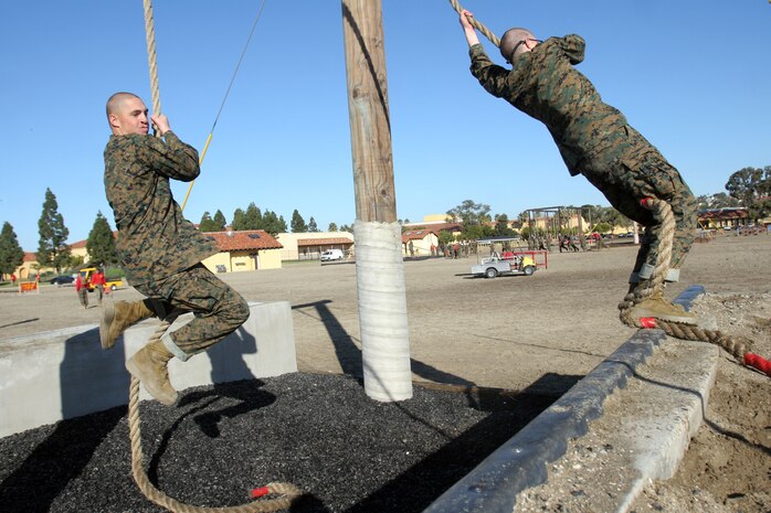Recruits of Company C, 1st Recruit Training Battalion, swing themselves across a gap to complete the Confidence Course aboard Marine Corps Recruit Depot San Diego Jan. 7. The various exercises are meant to challenge recruits and instill confidence.