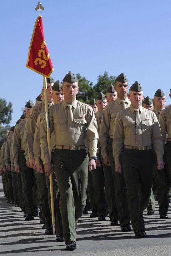 Lance Cpl. Adam Cardenas, company honorman, Mike Company, marches with the guidon leading platoon 3273 before commencing liberty for family day aboard Marine Corps Recruit Depot San Diego, Jan. 17. Cardenas joined the Marine Corps to be challenged, develop leadership skills and break out of his comfort zone.
