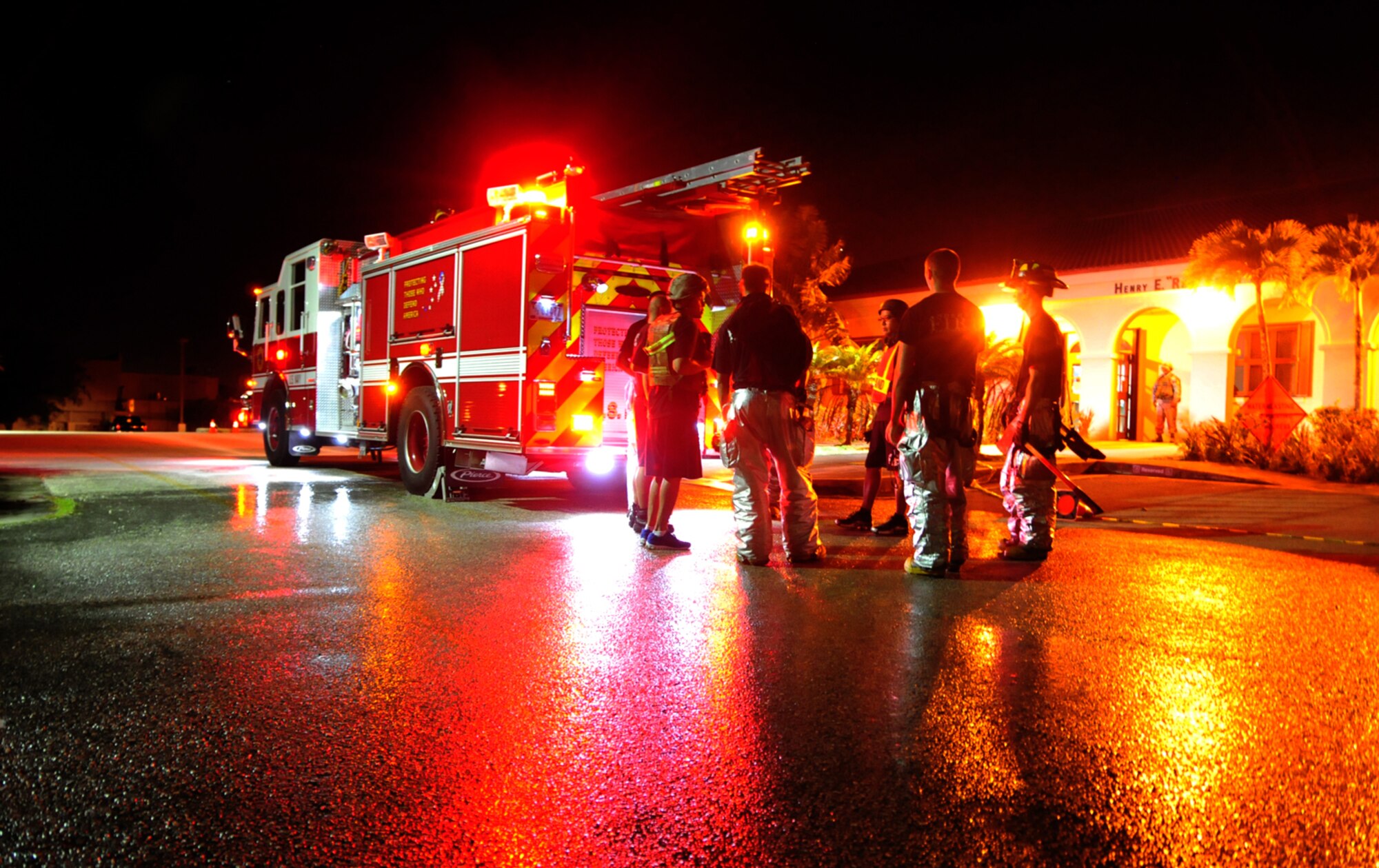 Firemen from the 36th Civil Engineer Squadron fire and emergency services receive feedback from an exercise evaluation team member after responding to a scenario during Operational Readiness Exercise Beverly Palm 13-01 on Andersen Air Force Base, Guam, Jan. 15, 2013. During Beverly Palm 13-01, executed from Jan. 13-16, Andersen Airmen practiced their ability to react, defend and execute operations in a wartime scenario. (U.S. Air Force photo/Airman 1st Class Marianique Santos/Released)