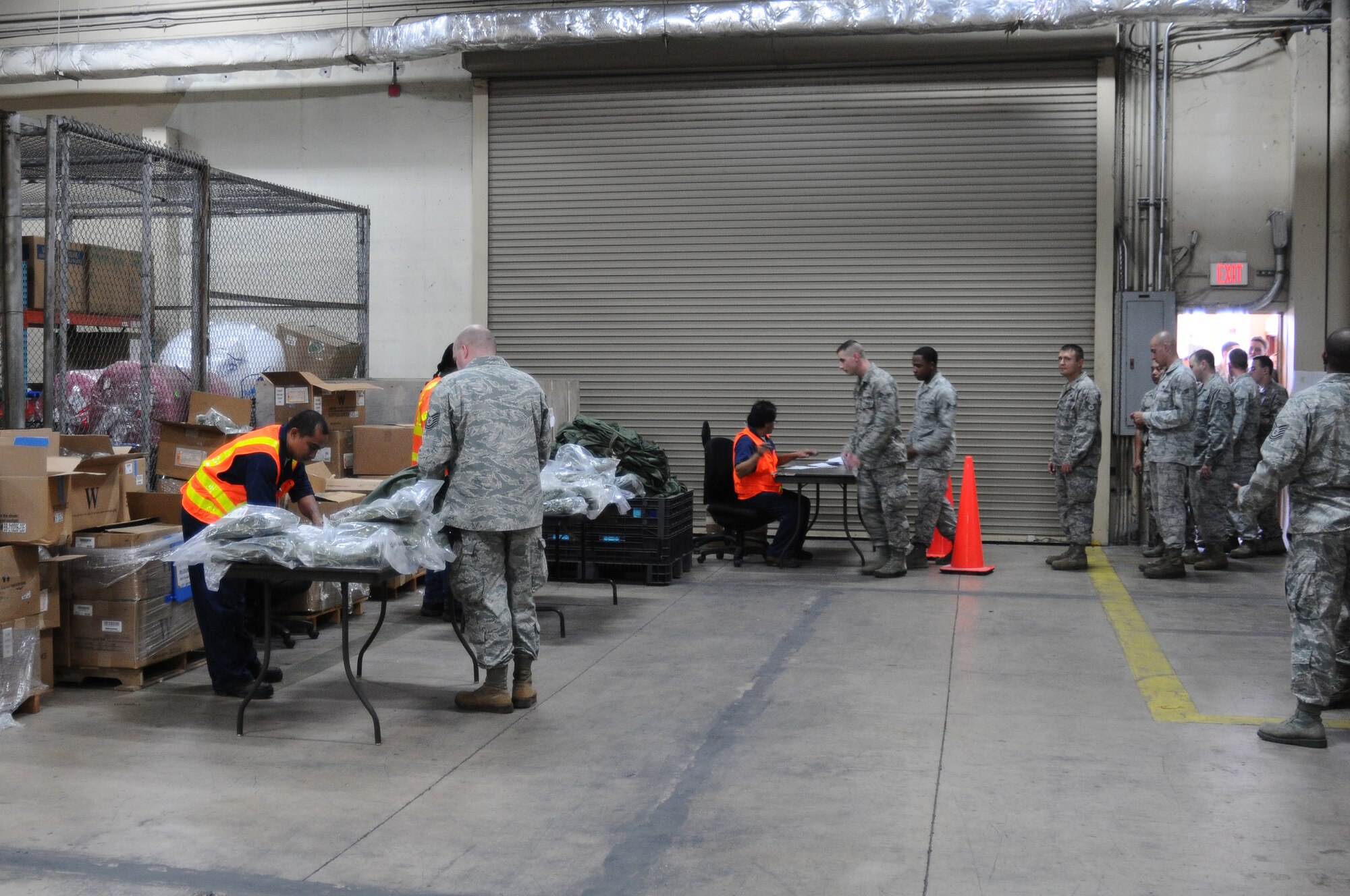 Airmen from the 644th Combat Communications Squadron process through the mobility rapid deployment line during an operational readiness exercise at Andersen Air Force Base, Guam, Jan. 14, 2013. During Beverly Palm 13-01, executed from Jan. 13-16, Andersen practiced mobilization with Osan Air Base, South Korea. (U.S. Air Force photo by Senior Airman Carlin Leslie/Released)