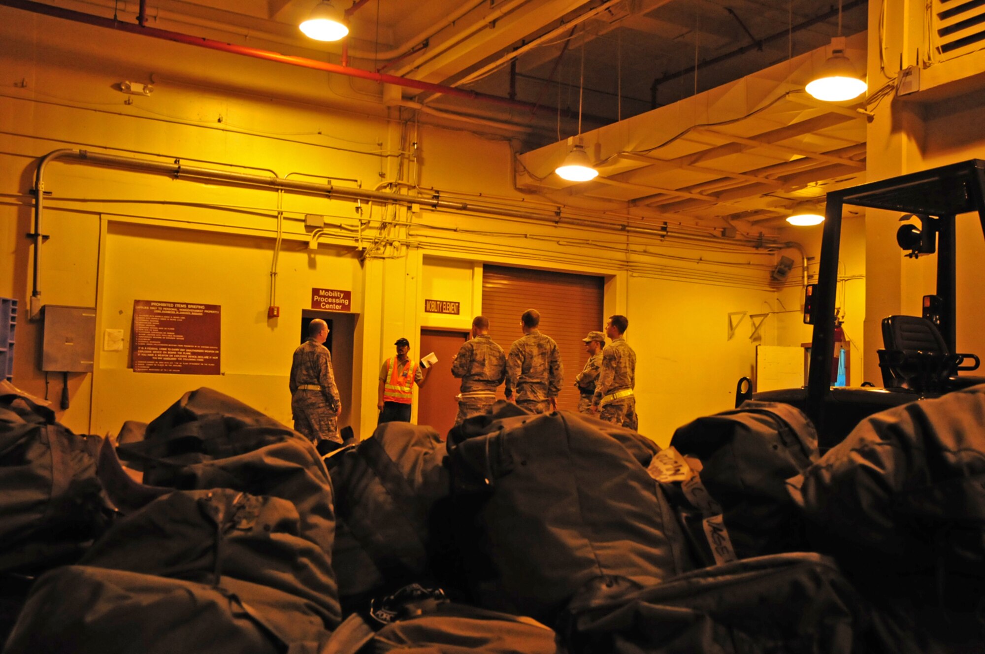Team Andersen Airmen prepare to process through the mobility processing center in preparation for a mock deployment during Operational Readiness Exercise Beverly Palm 13-01 on Andersen Air Force Base, Guam, Jan. 14, 2013. During Beverly Palm 13-01, executed from Jan. 13-16, Andersen practiced mobilization with Osan Air Base, South Korea. (U.S. Air Force photo by Airman 1st Class Marianique Santos/Released)
