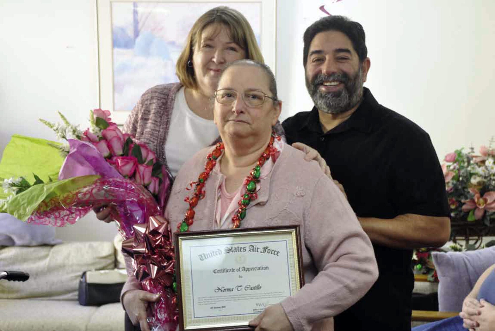 Mrs. Norma T. Castillo, center, retired after more than 43 years of Federal service, Thursday, Jan. 10. She proudly served her country with dedication, skill and leadership. Her career began July 22, 1969, where she met and overcame serious challenges and obstacles to successfully execute her assigned duties — many of those activities were accomplished as the year-end closeout monitor. During her career, she led the Budget Office at March Air Reserve Base, closing out fiscal years with an impressive record. (U.S. Air Force photo by Darnell Gardner)