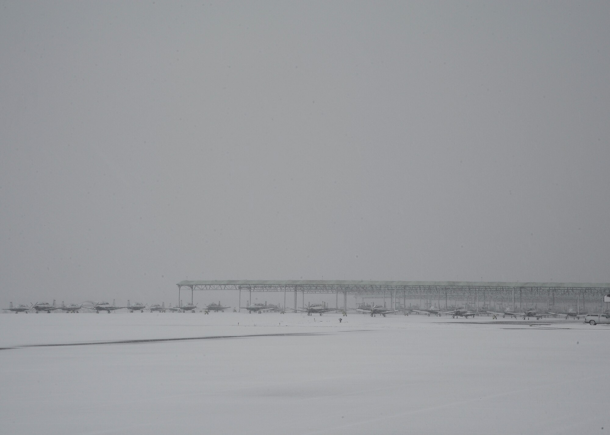 Snow descends on the Columbus Air Force Base aircraft ramp on Jan. 17. Weather improved and flying operations resumed that same afternoon.