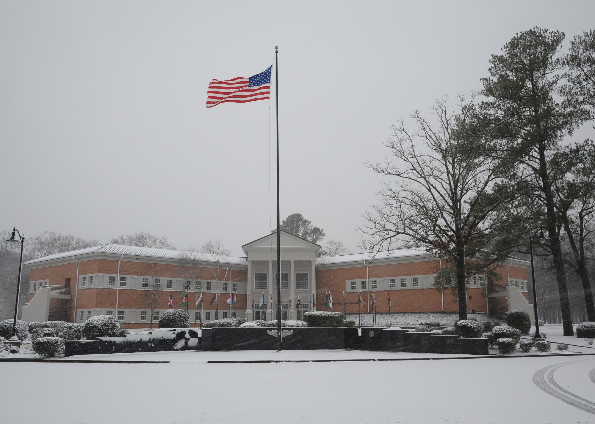 The Flag of the United States of America flies in front of the 14th Flying Training Wing headquarters building on Jan. 17. Columbus Air Force Base officially recieved two inches of snow Thursday morning according to measurements by the 14th Operations Support Squadron Weather Flight