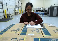 Rocio Oquendo, 50th Logistics Readiness Flight, inventories packages and cargos Jan. 15 at the flight's Secure Area Logistics Facility. The 50 LRF's mission is to conduct deployment planning, training and execution; base support planning, and logistics command and control in support of the Aerospace Expeditionary Force and Global Force Management construct. The flight performs logistics planning; manages the wing support agreements, mobility bags, deployment small-arms weapons, ammunition and transportation programs. (U.S. Air Force photo/Staff Sgt. Julius Delos Reyes)