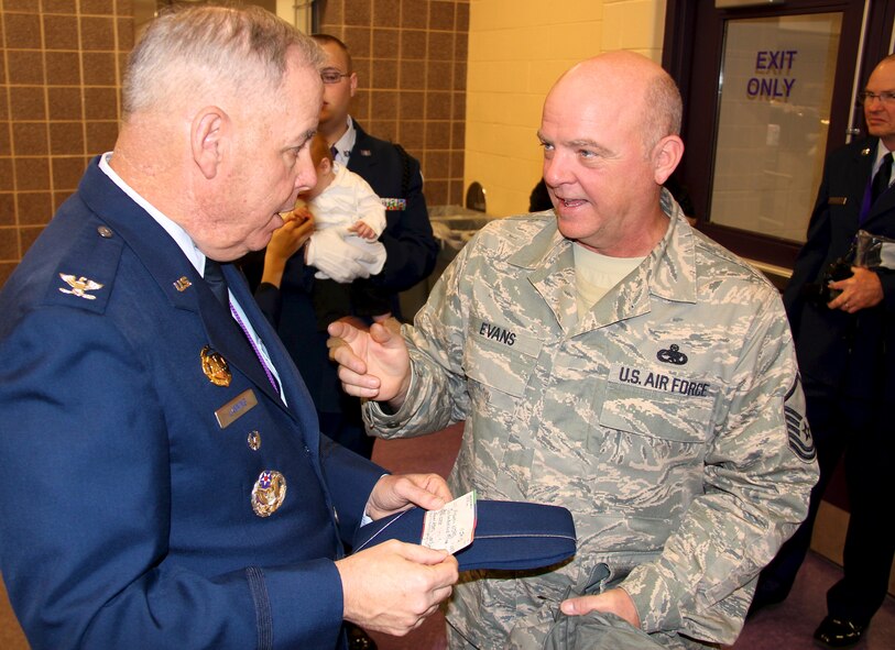 Master Sgt. Jimmie Evans chats with Col. Randall Lanning, commander, Air Force JROTC at Mascoutah High School.  Evans presented a $600 check to Lanning from the 932nd Airlift Wing Top Three organization on Jan. 17. The 932nd AW formally "adopted" the Mascoutah detachment in April 2010.  The 932nd AW, located at Scott Air Force Base, Illinois, is an Air Force Reserve unit that flies the C-40C.  (U.S. Air Force photo/Tech. Sgt. Daniel Oliver)  