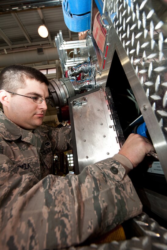 Staff Sgt. Evan Delk, 28th Logistics Readiness Squadron fire truck mechanic, installs a control module during scheduled maintenance on a fire truck at the Fire Department on Ellsworth Air Force Base, S.D., Jan. 14, 2013. The module controls the fire suppression system in the truck which permits Ellsworth fire protection Airmen to successfully manage fires. (U.S. Air Force photo by Airman 1st Class Kate Thornton-Maurer/Released)