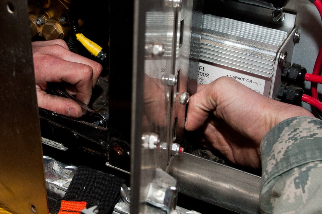 Airman 1st Class Jesse Barstad, 28th Logistics Readiness Squadron fire truck mechanic, removes bolts from a control module during scheduled maintenance on a fire truck in the Fire Department on Ellsworth Air Force Base, S.D., Jan. 14, 2013. Ellsworth is home to more than 10 fire trucks that are regularly maintained and annually inspected to guarantee reliable emergency response vehicles. (U.S. Air Force photo by Airman 1st Class Kate Thornton-Maurer/Released)
