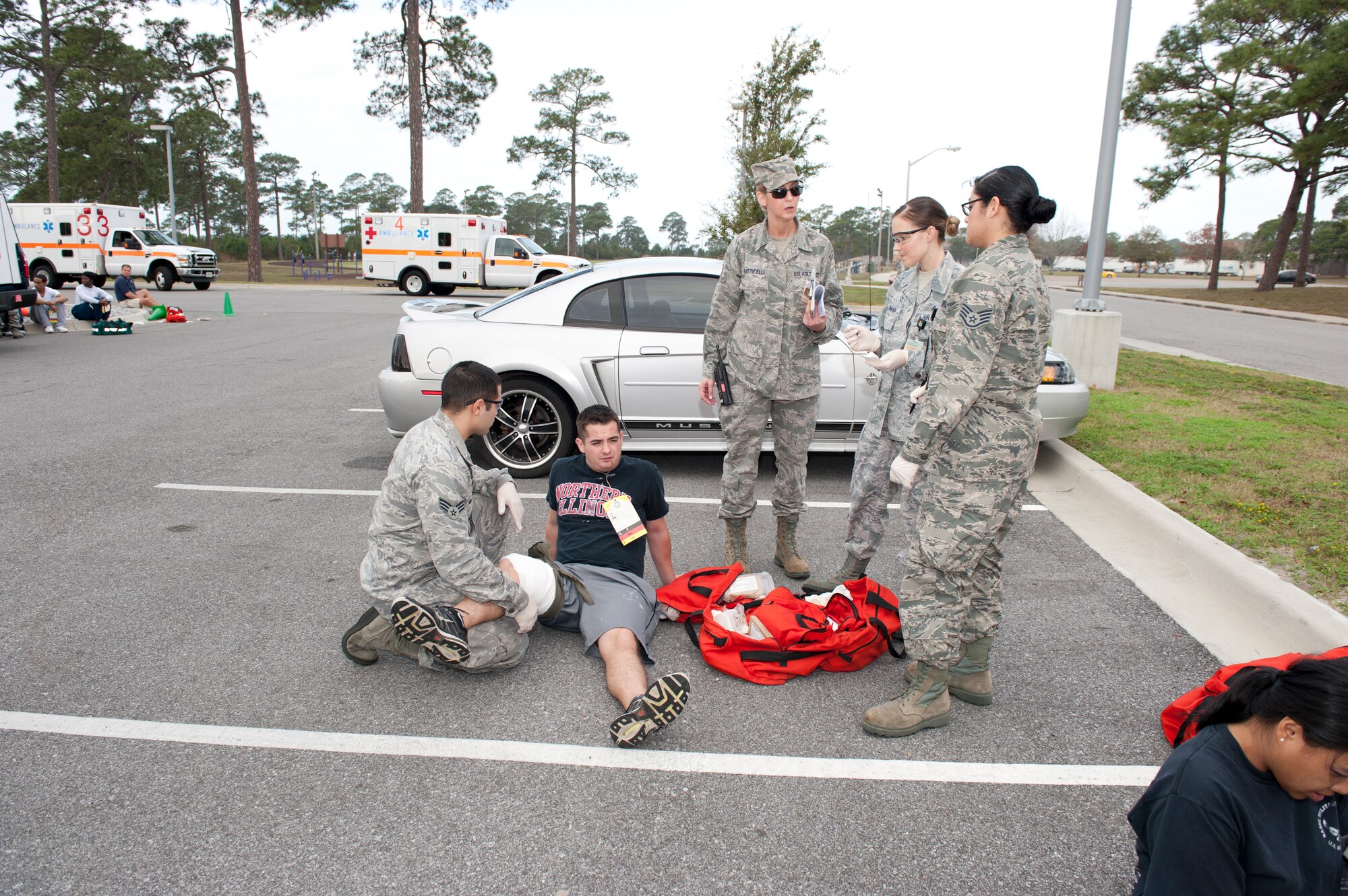325th Medical Group Airmen listen to instructions as they provide medical care to a "victim" of an active shooter in the base fitness center as part of a base exercise. The exercise is designed to provide an opportunity to validate training effectiveness and make changes where needed with minimal risk to personnel and property. Tyndall generally executes up to four exercises per year and scenarios vary. (U.S. Air Force photo by Lisa Norman)