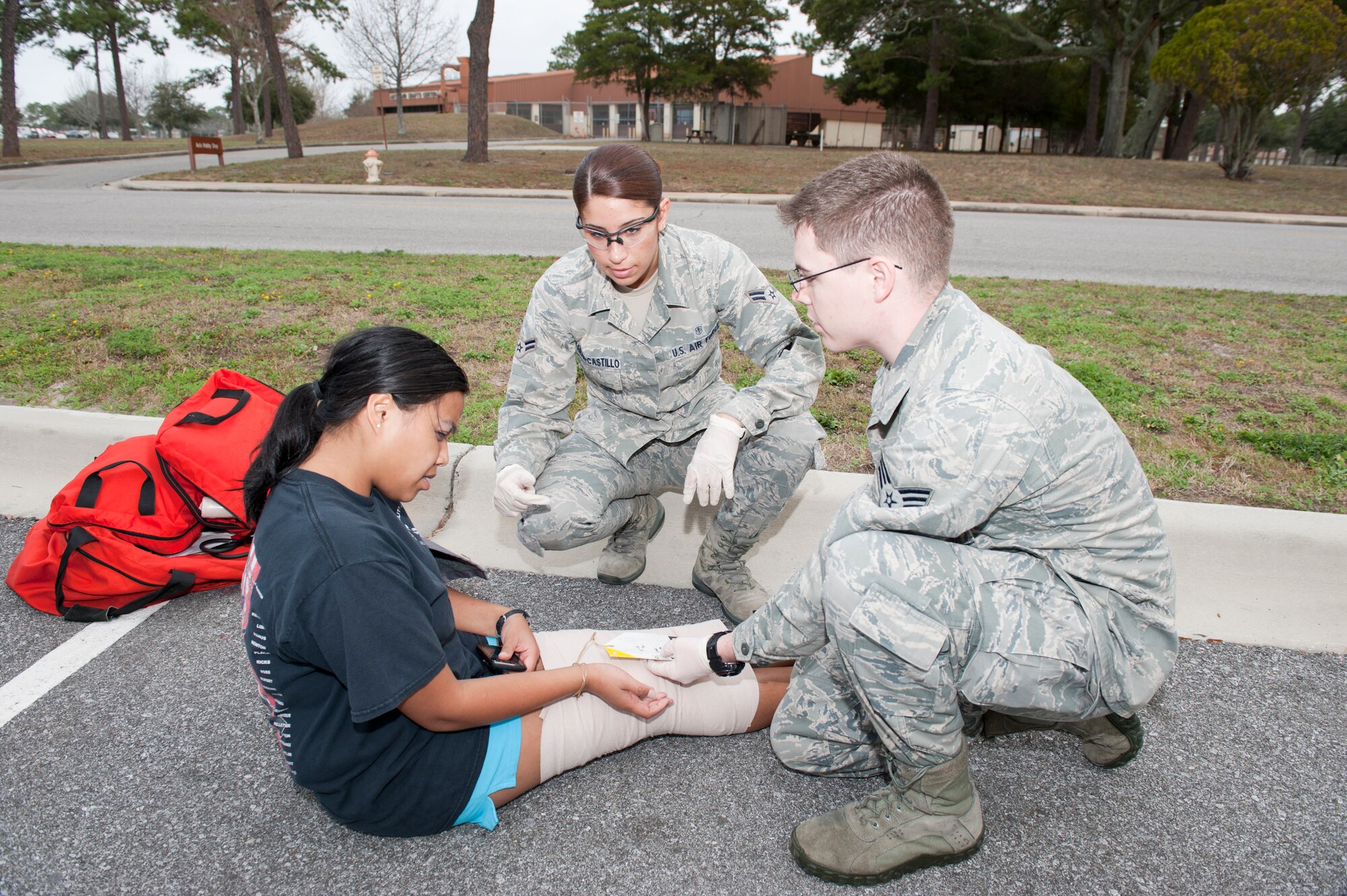 325th Medical Group Airmen provide medical care to a "victim" of an active shooter in the base fitness center as part of a base exercise. The exercise is designed to provide an opportunity to validate training effectiveness and make changes where needed with minimal risk to personnel and property. Tyndall generally executes up to four exercises per year and scenarios vary. (U.S. Air Force photo by Lisa Norman)