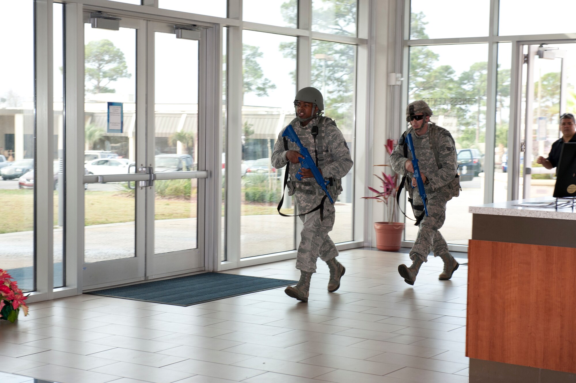 325th Security Forces Squadron Airmen enter the fitness center as part of a response to a call about shots fired during a base exercise. The exercise is designed to provide an opportunity to validate training effectiveness and make changes where needed with minimal risk to personnel and property. Tyndall generally executes up to four exercises per year and scenarios vary. (U.S. Air Force photo by Lisa Norman)