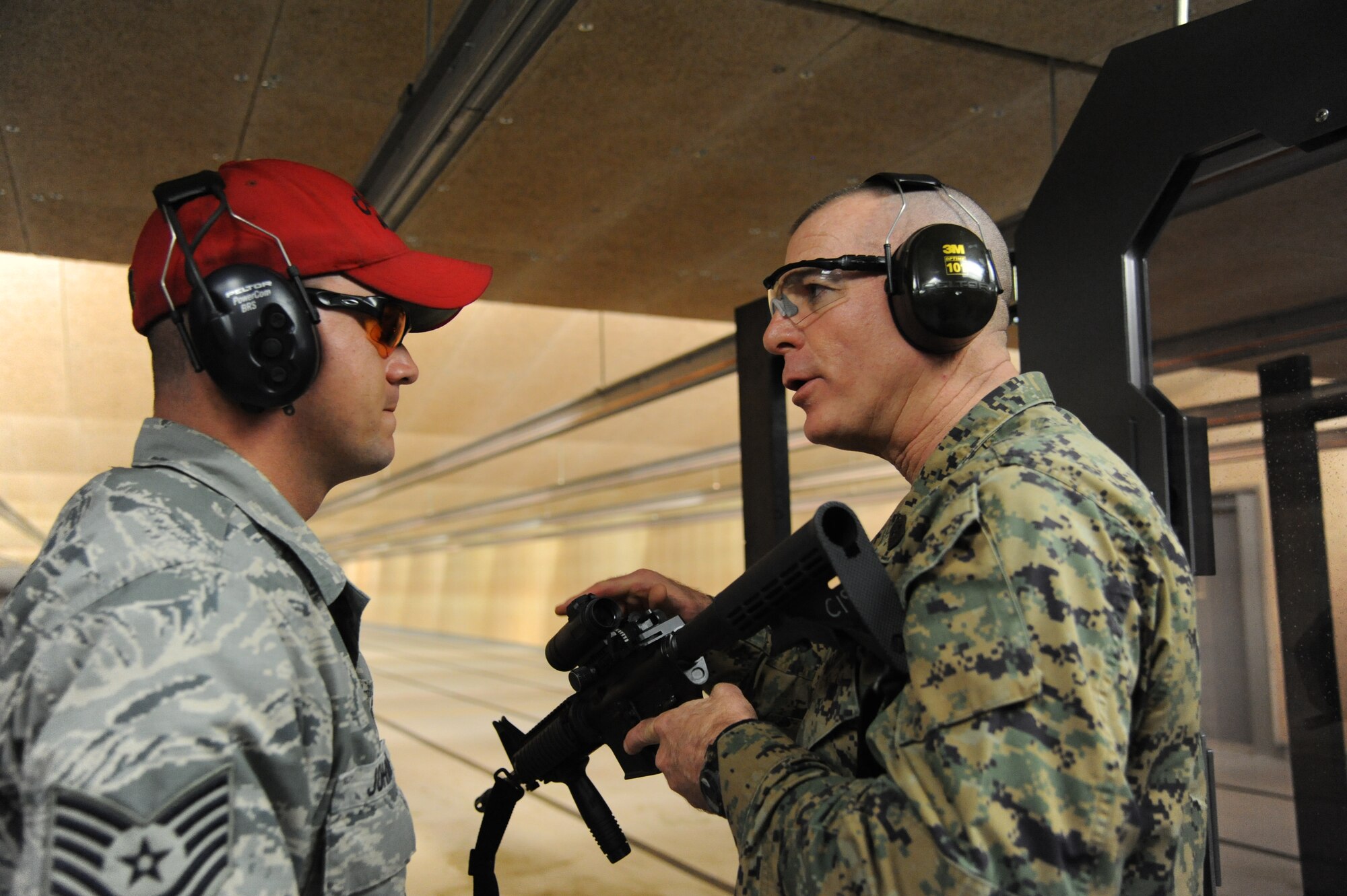 Tech. Sgt. Jonathan Johnson, 81st Security Forces combat arms, answers questions from Marine Sgt. Maj. Bryan Battaglia, Senior Enlisted Advisor to the Chairman of the Joint Chiefs of Staff, about training with an M4 assault rifle at the indoor firing range Jan. 16, 2013, at Keesler Air Force Base, Miss.  Battaglia’s one-day visit allowed him the opportunity to acquaint himself with Keesler’s people, mission and contribution to the bigger military picture.  He also talked to enlisted Keesler members about the CJCS’ four priorities, his own key themes and his thoughts on bridging the basics and total force fitness.  (U.S. Air Force photo by Kemberly Groue)
