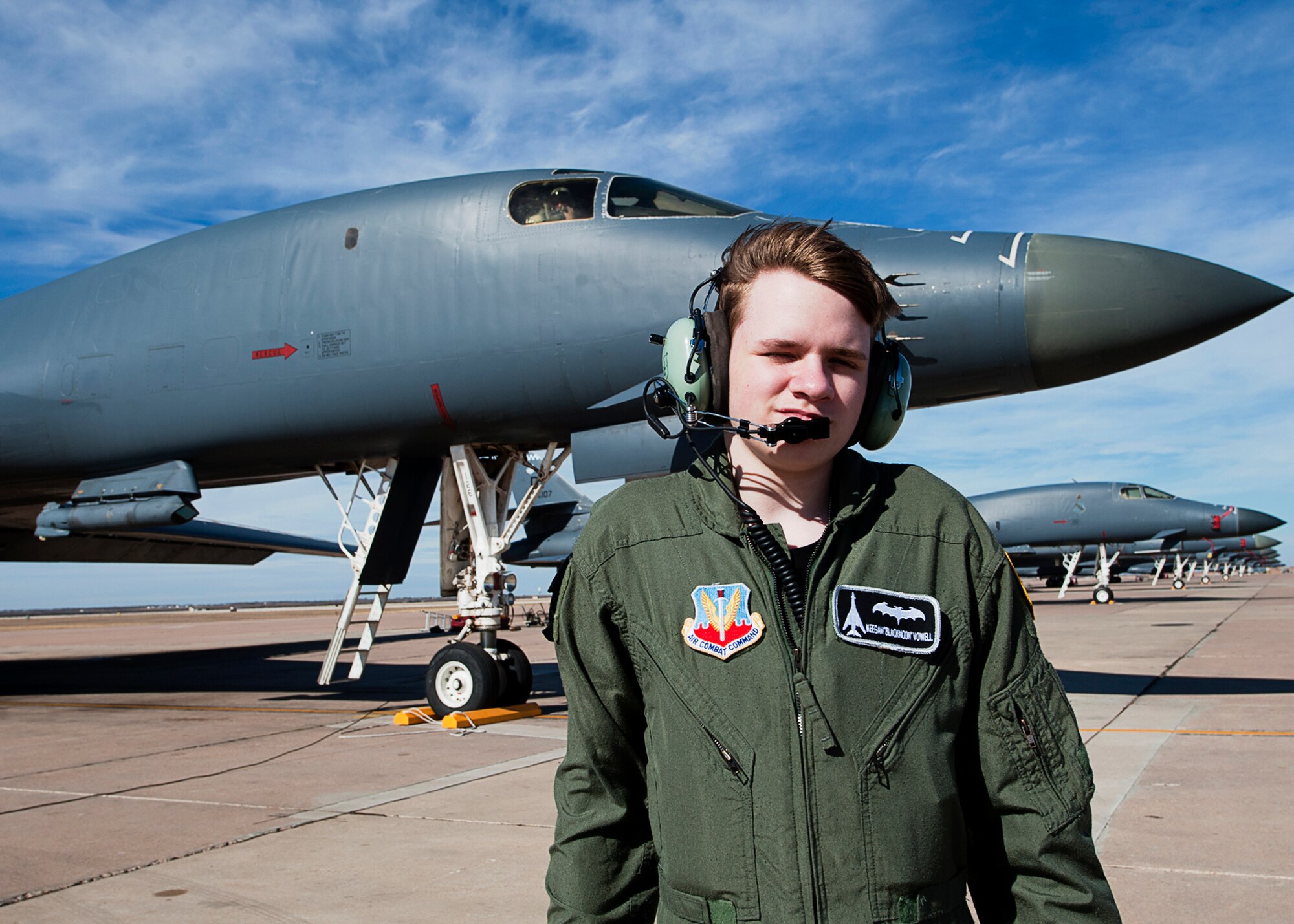 Keegan Vowell, 16-year-old Abilene resident, poses in front of B-1 Bomber during the “Pilot for a Day” tour Jan. 14, 2013, at Dyess Air Force Base, Texas. As part of the program, Keegan received his own flight suit, was demonstrated the capabilities of the 7th Security Forces K-9 Unit, toured the air traffic control tower, taxied a bomber, had his name put onto an aircraft, created his own Hollywood explosion with the 7th Civil Engineer Squadron Explosive Ordinance Disposal Unit and was presented a coin from the base commander. (U.S. Air Force photo by Airman 1st Class Damon Kasberg/ Released)