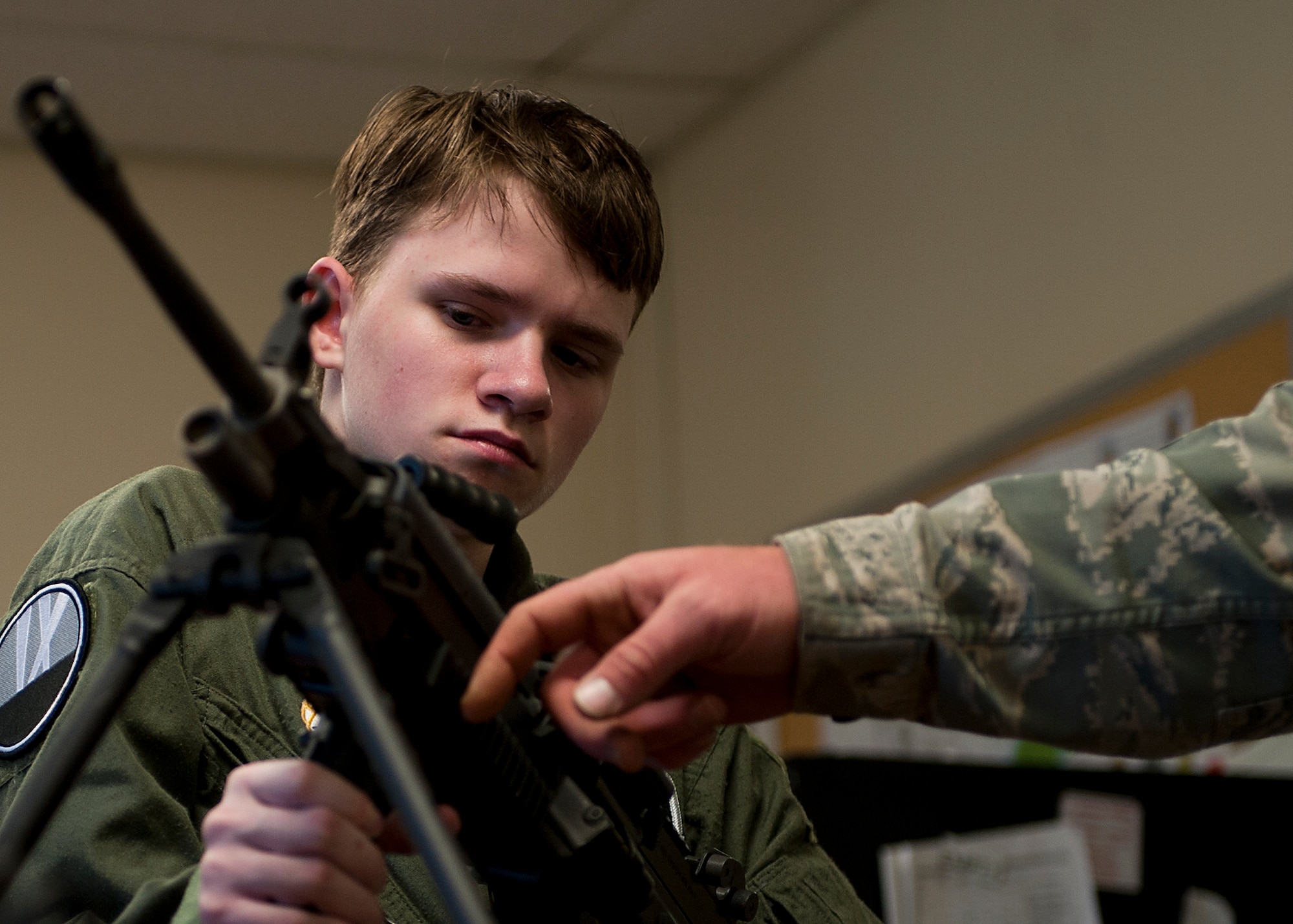 Keegan Vowell, 16-year-old Abilene resident, holds a M249 during a “Pilot for a Day” tour Jan. 14, 2013, at Dyess Air Force Base, Texas. As part of the program, Keegan received his own flight suit, was demonstrated the capabilities of the 7th Security Forces K-9 Unit, toured the air traffic control tower, taxied a bomber, had his name put onto an aircraft, created his own Hollywood explosion with the 7th Civil Engineer Squadron Explosive Ordinance Disposal Unit and was presented a coin from the base commander. (U.S. Air Force photo by Airman 1st Class Damon Kasberg/ Released)