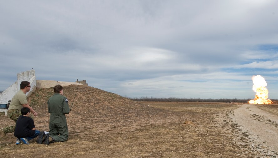 Keegan Vowell, 16-year-old Abilene resident, blows up a car during a “Pilot for a Day” tour Jan. 14, 2013, at Dyess Air Force Base, Texas. Throughout the event, Keegan received his own flight suit, was demonstrated the capabilities of the 7th Security Forces K-9 Unit, toured the air traffic control tower, taxied a bomber, had his name put onto an aircraft, created his own Hollywood explosion with the 7th Civil Engineer Squadron Explosive Ordinance Disposal Unit and was presented a coin from the base commander. (U.S. Air Force photo by Airman 1st Class Jonathan Stefanko/ Released)