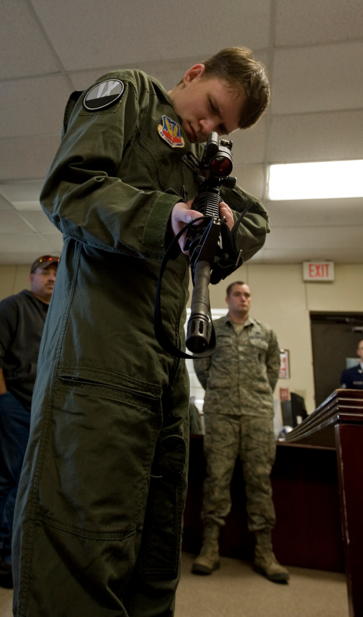 Keegan Vowell, 16-year-old Abilene resident, looks down the sights of an M-4 during a “Pilot for a Day” tour Jan. 14, 2013, at Dyess Air Force Base, Texas. Throughout the event, Keegan received his own flight suit, was demonstrated the capabilities of the 7th Security Forces K-9 Unit, toured the air traffic control tower, taxied a bomber, had his name put onto an aircraft, created his own Hollywood explosion with the 7th Civil Engineer Squadron Explosive Ordinance Disposal Unit and was presented a coin from the base commander. (U.S. Air Force photo by Airman 1st Class Jonathan Stefanko/ Released)