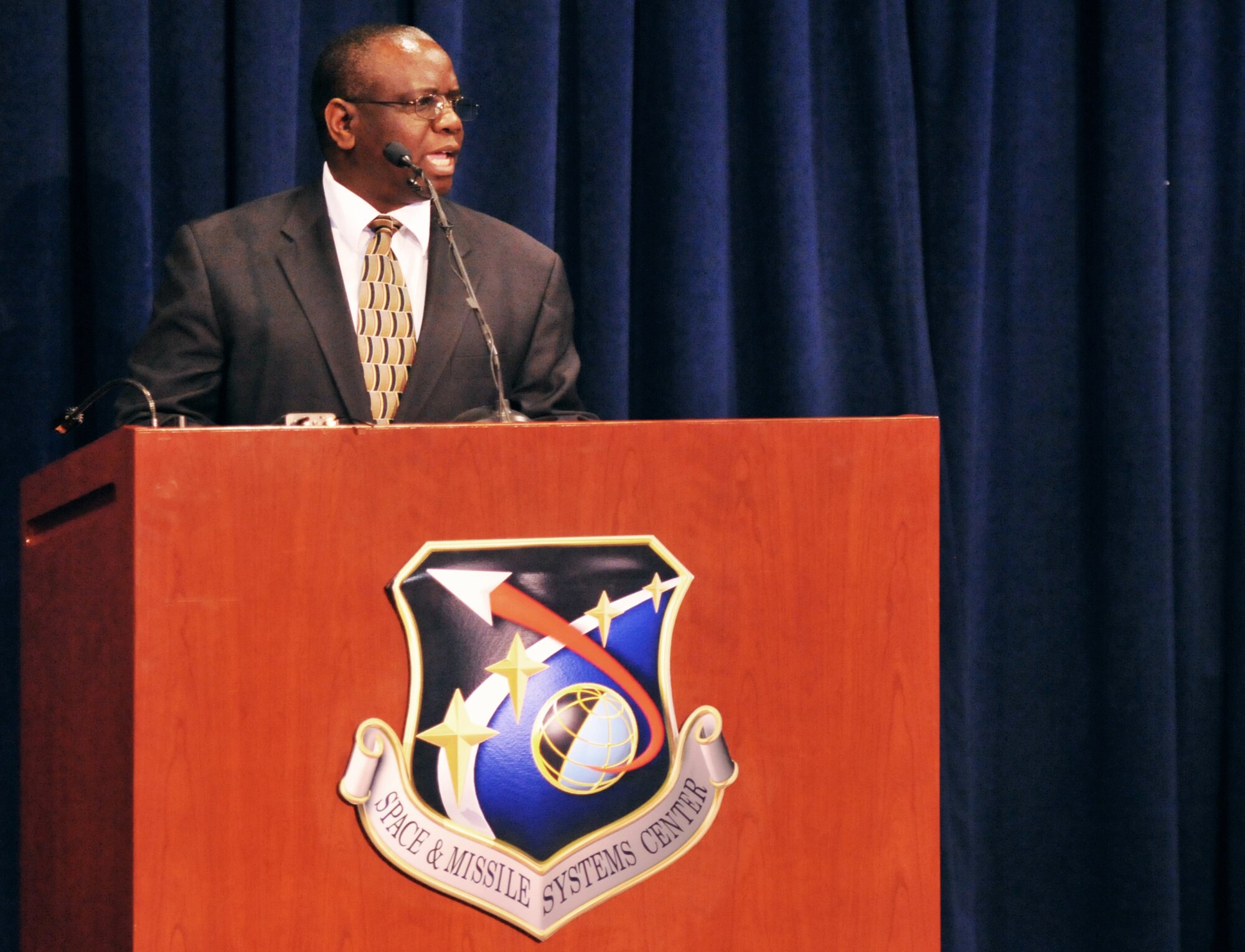 Dr. Munashe Furusa, associate professor of Africana studies at California State University Dominguez Hills, speaks about team work making the dream work during SMC’s MLK observance, Jan.16.   The observance included a reenactment of one of Dr. King’s speeches by Anthony Heard and remarks by Lt. Gen. Ellen Pawlikowski, SMC commander, and Dr. Wayne Goodman, Aerospace Corporation’s vice president of Space Program Operations. (Photo by Sarah Corrice)