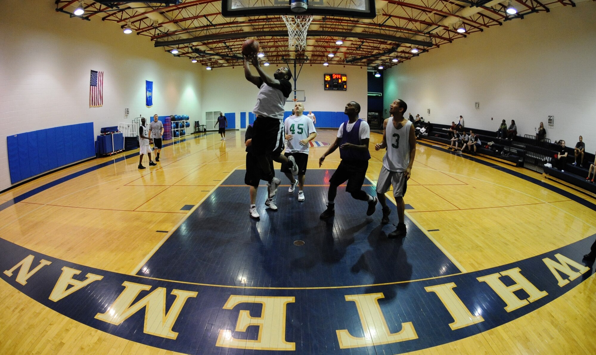 WHITEMAN AIR FORCE BASE, Mo. -- Dionte Maxwell, 509th Aircraft Maintenance Squadron-B team intramural basketball team member, drives through the paint for a layup against the 509th Logistics Readiness Squadron at the Fitness Center, Jan. 10. Intramural basketball games foster a spirit of both competition and camaraderie among Airmen. (U.S. Air Force photo/Airman 1st Class Bryan Crane)(Released)