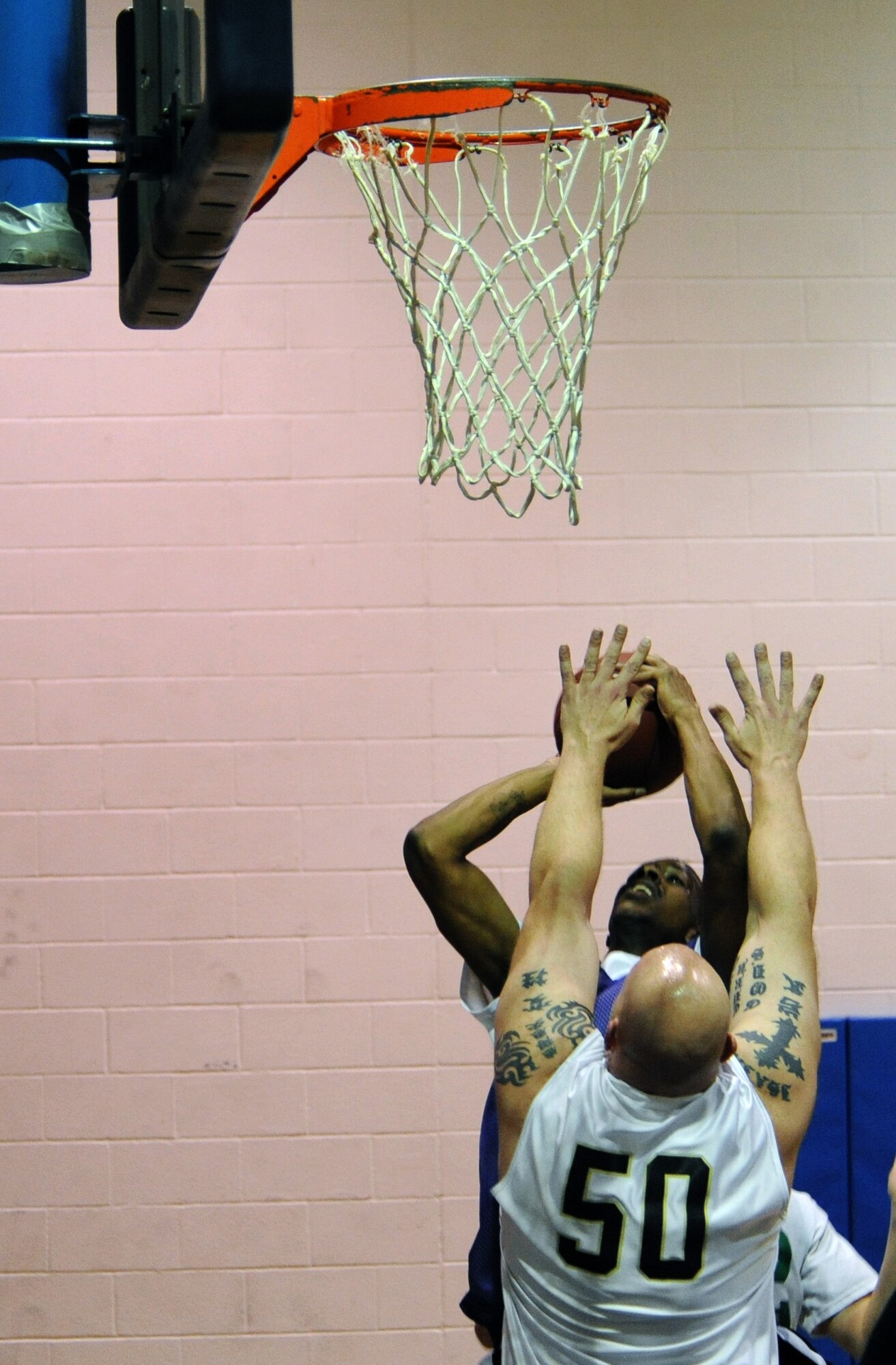 WHITEMAN AIR FORCE BASE, Mo. -- Daniell Branch, 509th Logistics Readiness Squadron intramural basketball team member, releases a jump shot over a defender from the Aircraft Maintenance Squadron-B team at the Fitness Center, Jan. 10. LRS took the lead in the third quarter and would go on to win, 54-49.  (U.S. Air Force photo/Airman 1st Class Bryan Crane)(Released)