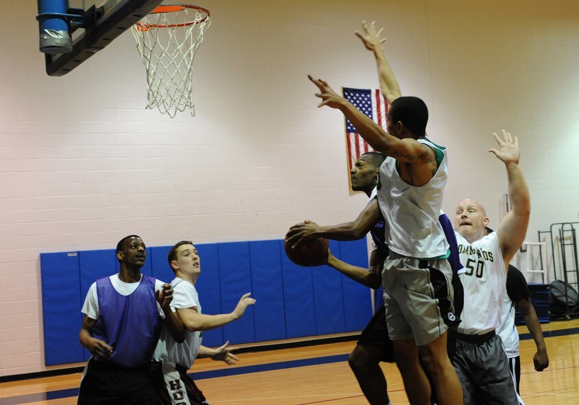 WHITEMAN AIR FORCE BASE, Mo. -- Daniell Branch, 509th Logistics Readiness Squadron intramural basketball team member, drives for a layup against the 509th Aircraft Maintenance Squadron-B team at the Fitness Center, Jan. 10. LRS began the game without much momentum and trailed 15-8 at the end of the first quarter. (U.S. Air Force photo/Airman 1st Class Bryan Crane)(Released)
