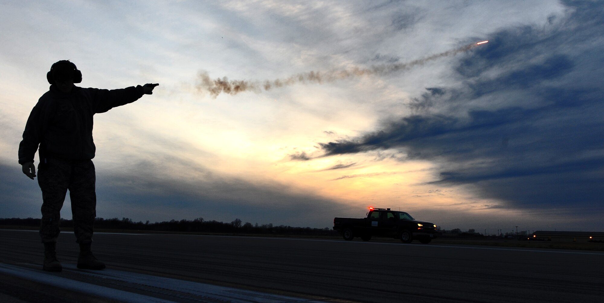 WHITEMAN AIR FORCE BASE, Mo. -- Airman 1st Class Hannah Schmitz, 509th Operations Support Squadron airfield management coordinator, shoots pyrotechnics to disperse a bird threat on the flightline, Jan. 9. Along with ensuring the general safety of those who work on the flightline, airfield management specialists participate in the base’s Bird Air Strike Hazard program to keep birds from posing a threat to flying aircraft. (U.S. Air Force photo/Staff Sgt. Nick Wilson) (Released)