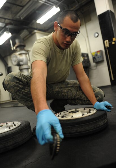 WHITEMAN AIR FORCE BASE, Mo. – Airman 1st Class Christian Liuchan, 509th Maintenance Squadron B-2 Spirit crew chief, disassembles the wheel of a T-38 Talon, Jan. 9. All T-38 wheels are filled to 265 pounds per square inch. (U.S. Air Force photo/Airman 1st Class Bryan Crane) (Released)