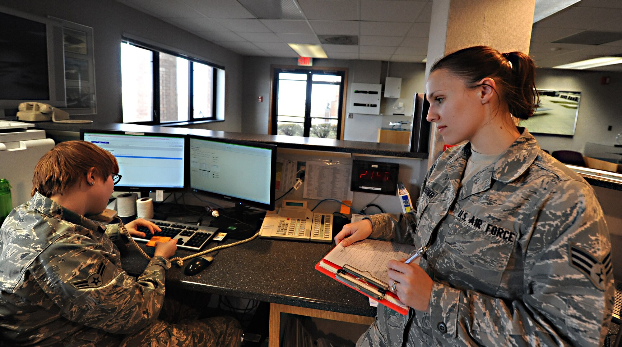 WHITEMAN AIR FORCE BASE, Mo. -- Airman 1st Class Hannah Schmitz, 509th Operations Support Squadron airfield management coordinator, and Senior Airman Alessandra Aceves-Harnden, 509th OSS airfield management coordinator, receive notification of a possible Bird Aircraft Strike Hazard, Jan. 9. Airfield management coordinators are responsible for updating bird-watch conditions, which let pilots and air-traffic controllers know what BASH threat level they can expect on flying days. (U.S. Air Force photo/Staff Sgt. Nick Wilson) (Released)