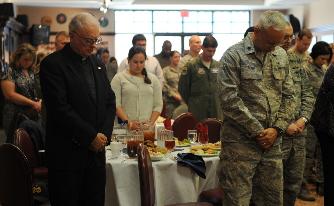 Members of Team Beale bow in prayer during at National Prayer Luncheon at the Recce Point Club at Beale Air Force Base Calif., Jan. 15, 2013. The base chapel staff hosted the luncheon to promote unity between all faiths and spiritual fitness. (U.S. Air Force photo by Staff Sgt. Robert M. Trujillo/Released)